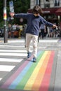 Young careful child crossing the street with fun, city background