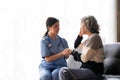 Young caregiver helping senior woman walking. Nurse assisting her old woman patient at nursing home. Senior woman with Royalty Free Stock Photo