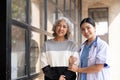 Young caregiver helping senior woman walking. Nurse assisting her old woman patient at nursing home. Senior woman with Royalty Free Stock Photo