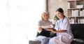 Young caregiver helping senior woman walking. Nurse assisting her old woman patient at nursing home. Senior woman with Royalty Free Stock Photo