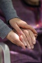 Young caregiver holding seniors hand. Elderly concept