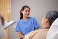 Young caregiver or nurse care and talking patient elderly on bed for consoling in room at hospital ward. Royalty Free Stock Photo