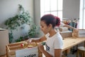 Young caring girl putting groceries in donation box.