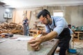 Young carpenter caucasian man using measuring tape looking wood size at workspace. craftsman profession in wood factory Royalty Free Stock Photo