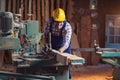 Carpenter doing his job in carpentry workshop. Royalty Free Stock Photo