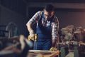 Carpenter drills a hole with an electrical drill