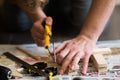 Young carpenter, handyman working with wood, cutting with handsaw Royalty Free Stock Photo