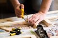 Young carpenter, handyman working with wood, cutting with handsaw Royalty Free Stock Photo