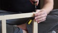 Young carpenter, handyman working with wood, using a screwdriver