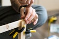Young carpenter, handyman working with wood, using a screwdriver Royalty Free Stock Photo