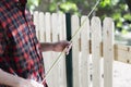 Young carpenter measuring wood using a tape measure  in the garden Royalty Free Stock Photo