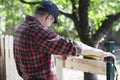 Young carpenter measuring wood using a tape measure Royalty Free Stock Photo