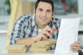 Young carpenter sanding wooden plank in workshop Royalty Free Stock Photo