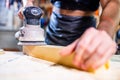 Young carpenter sawing board with circular saw Royalty Free Stock Photo