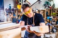 Young carpenter sawing board with circular saw Royalty Free Stock Photo