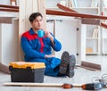 Young carpenter taking break from working with wooden planks Royalty Free Stock Photo