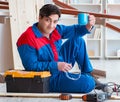 Young carpenter taking break from working with wooden planks Royalty Free Stock Photo