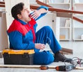 Young carpenter taking break from working with wooden planks Royalty Free Stock Photo