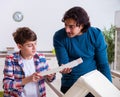 Young carpenter teaching his son