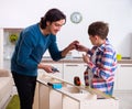 Young carpenter teaching his son