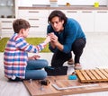 Young carpenter teaching his son