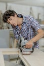 Young carpenter using belt sander Royalty Free Stock Photo