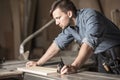 Young carpenter using measuring tape Royalty Free Stock Photo