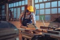 Carpenter working with circular saw at carpentry workshop Royalty Free Stock Photo