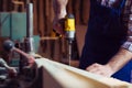 Carpenter working with a hand tool on the work bench Royalty Free Stock Photo