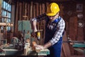 Carpenter working with a hand tool on the work bench Royalty Free Stock Photo