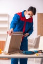 Young male carpenter working in the office during pandemic