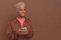 Young casual African American woman zoomer uses mobile phone for online chatting Royalty Free Stock Photo