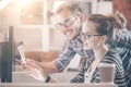 Young Casual business couple using computer in the office. Two colleagues working together on an innovative product design Royalty Free Stock Photo