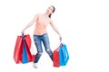 Young casual lady carrying heavy gift bags