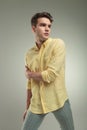 Young casual man holding his right arm Royalty Free Stock Photo