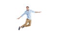 Young casual man jumping with arms outstretched Royalty Free Stock Photo