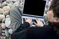 Young casual man with laptop computer in the beach Royalty Free Stock Photo