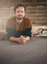 Young casual man looking thoughtful in his studio