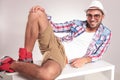 Young casual man resting on a white table Royalty Free Stock Photo