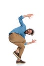 Young casual man standing on one leg and fooling around Royalty Free Stock Photo