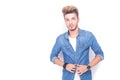 Young casual man unbuttoning his jeans shirt Royalty Free Stock Photo