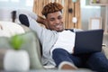 young casual man using pc on sofa Royalty Free Stock Photo