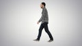 Young casual man walking on gradient background. Royalty Free Stock Photo