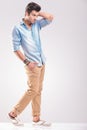 Young casual man walking on grey studio background Royalty Free Stock Photo