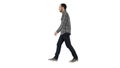 Young casual man walking on white background.