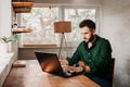 Young casual man working on a laptop