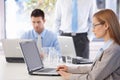 Young casual office workers working on laptop