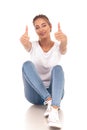 Young casual seated woman making the ok sign