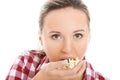 Young casual woman eating popcorn. Royalty Free Stock Photo