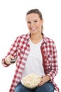 Young casual woman with remote control and bowl of popcorn. Royalty Free Stock Photo